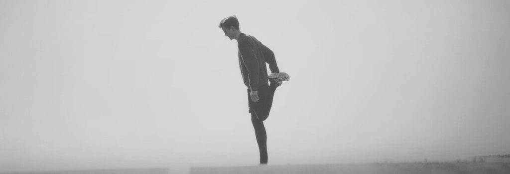 man stretching his hamstring
